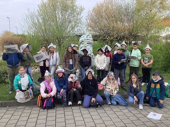 Schüler und Schülerinnen mit Zeitungen und dem Zeitungszwerg am Druckhaus der Stimme in Heilbronn