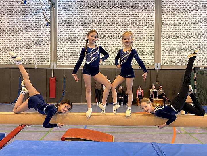 Turnerinnen der Grundschule im Rot auf dem Schwebebalken